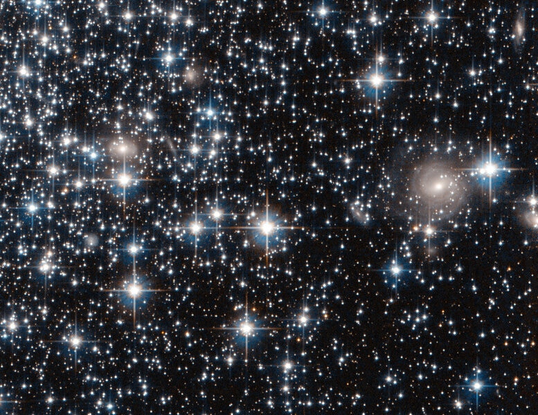 Detail of the Hubble image of globular cluster IC 4499 shows many faint stars, and even distant background galaxies! Credit: ESA / Hubble / NASA