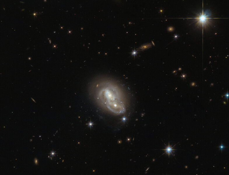 The galaxies collectively known as IRAS 06076-2139 are weakly interacting, but they’ve had an exciting past. Credit: ESA/Hubble &amp; NASA