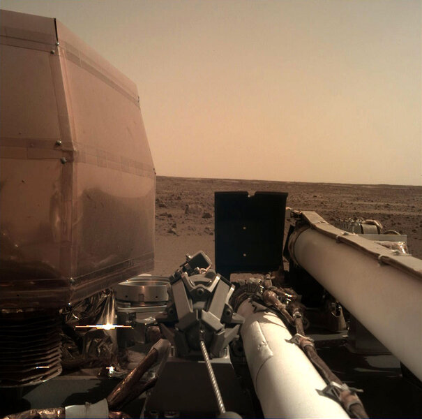 First light for the Instrument Deployment Camera on NASA’s Mars InSight lander. You can see various instruments on the deck, including the segments of the robot arm, and Mars beyond. Credit: NASA/JPL-Caltech