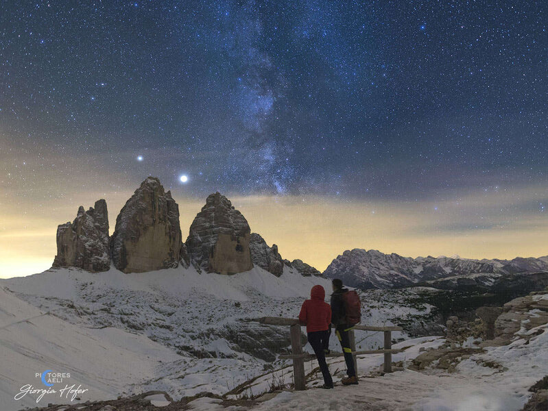 A couple, including the photographer, watch Jupiter and Saturn and the Milky Way over the Tre Cime di Lavaredo in the Italian Alps in early October 2020. Credit: Giorgia Hofer
