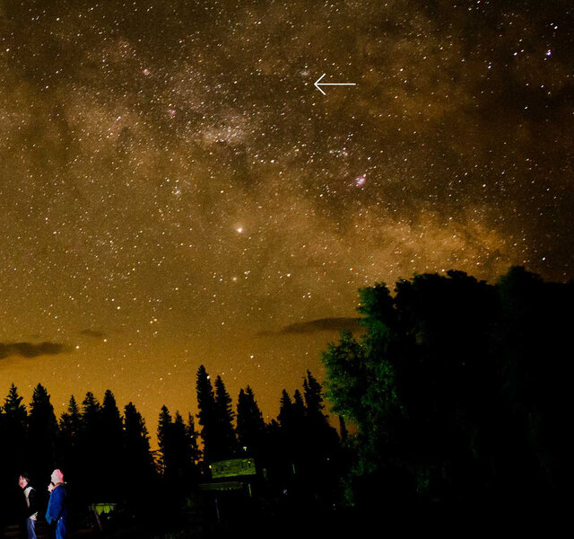 The night sky from rural Colorado, showing the Milky Way, some folks gathered ‘round a telescope (that’s me on the right), and the protoplanet Vesta (arrowed). Credit: Michele Wedel