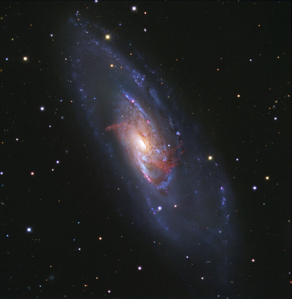 The galaxy M 106, in observations taken by Hubble Space Telescope combined with two smaller (but wider field of view) telescopes. The inner red arms aren’t actually spiral arms, but gas heated by a supermassive black hole.