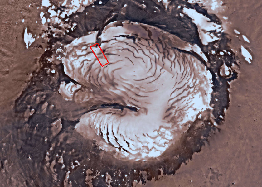 An overview of the north pole of Mars shows the ice cap and swirled pattern of wind-eroded troughs. The outline is the rough area shown in the main image. Credit: Mars Trek/NASA/JPL-Caltech