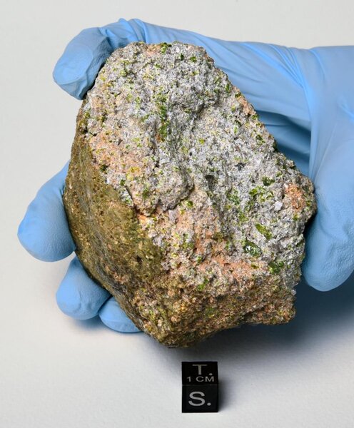 The meteorite NWA 11119 is an unusually old igneous rock, formed via volcanism on a long-gone pre-planetary object on our solar system. Note the green pyroxene crystals. Credit: B. Barrett / Maine Mineral & Gem Museum