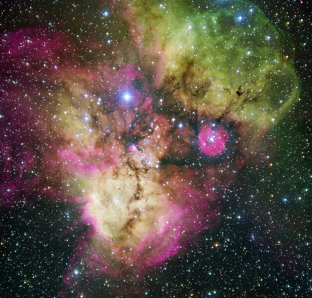 Gas and dust clouds busily churn out stars in the constellation of Puppis, including NGC 2467 (bottom) and Haffner 19 (pink circle on middle right). Credit: ESO
