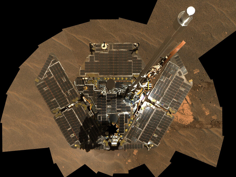 A self-portrait of Opportunity taken by combining several images. The camera is located on a mast (blocked by the series of black cutouts near the bottom of the image) and cannot be seen when the images are combined. 