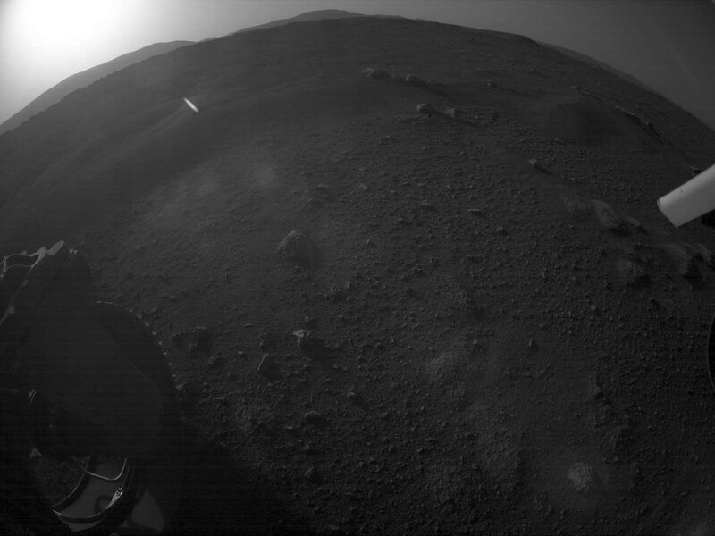 Perseverance’s first sunset was spotted by one of its hazard avoidance cameras on its first sol on Mars (the glow to the upper left is the Sun). The camera uses a fish-eye lens, distorting perspective. Credit: NASA/JPL-Caltech