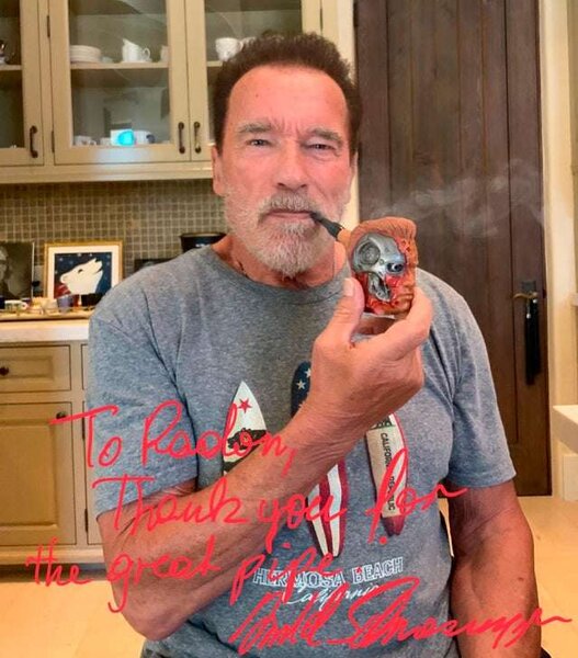 Photo of Arnold Schwarzenegger smoking his gift pipe