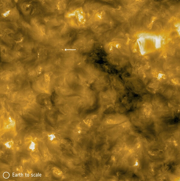 An image of the Sun from Solar Orbiter shows a “campfire” (arrowed), a small burst of energy that appears to be happening all over the Sun’s surface. This image is about 380,000 km wide (about the distance from the Earth to the Moon)