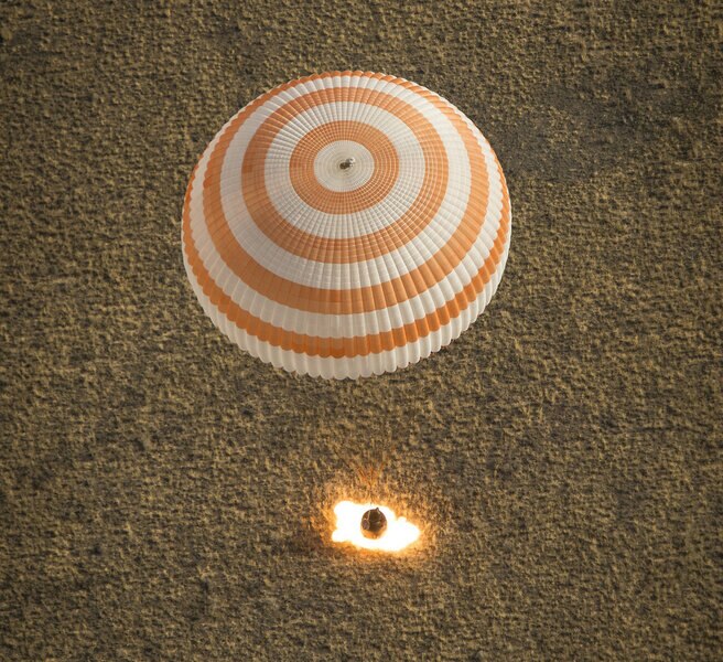 Actual photo of a Soyuz using its soft landing rocket to slow the capsule before it hits the ground. Credit: NASA/Bill Ingalls