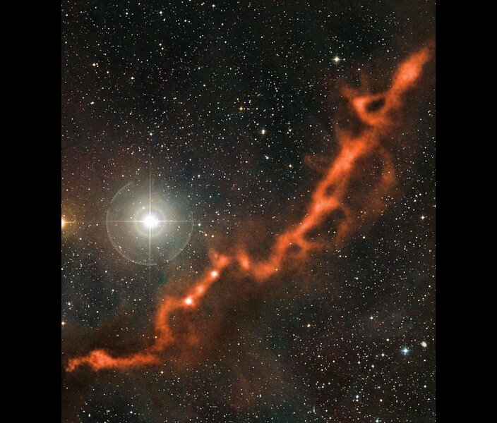 The bright star Phi Tauri shines in visible light (along with thousands of other stars) while a river of cold gas and dust glows in millimeter wavelengths in this image consisting of two superposed observations.