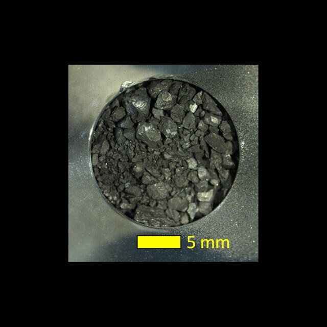 A sample of the asteroid Ryugu collected by the Hayabusa2 spacecraft shows rocks up to roughly a centimeter in size, and extremely dark.