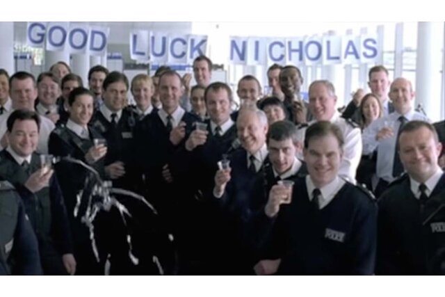 Police officers giving a thumbs up  with a "Good Luck Nicholas" sign.