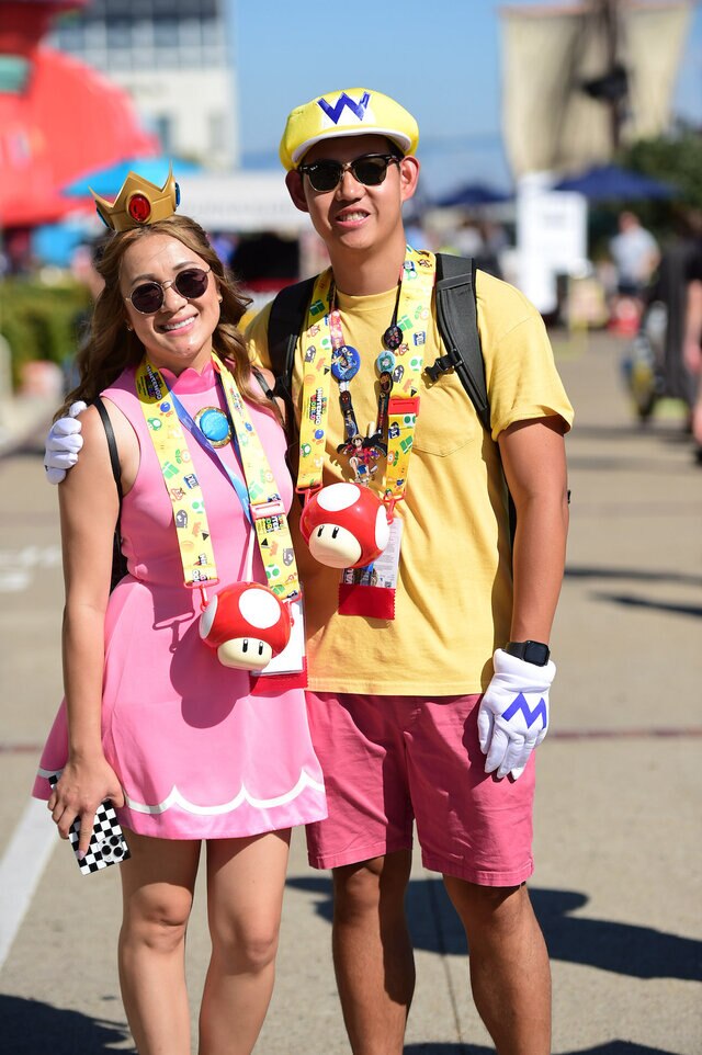 Cosplayers dress as Princess Peach and Wario on Day 2 of SDCC 2023