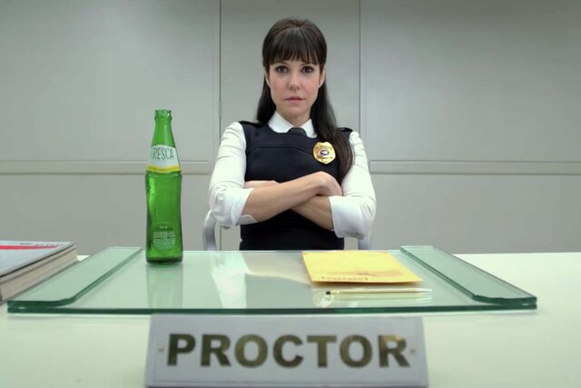 Proctor (Mary-Louise Parker) sits at a desk in R.I.P.D. (2013)