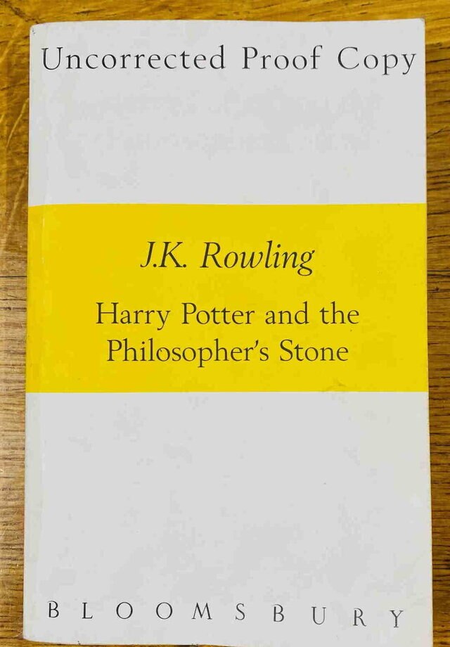 The ‘Uncorrected Proof Copy’ of Harry Potter and the Philosopher’s Stone featuring a white cover with a yellow banner.