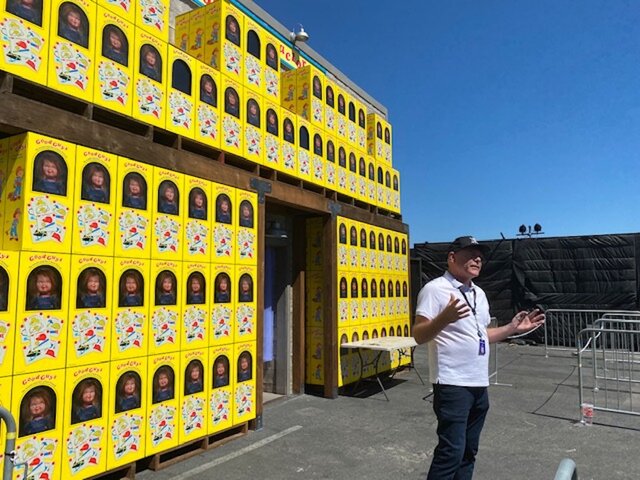 A man speaks near stacked Chucky boxes at Universal Studios Hollywood Halloween Horror Nights 2023