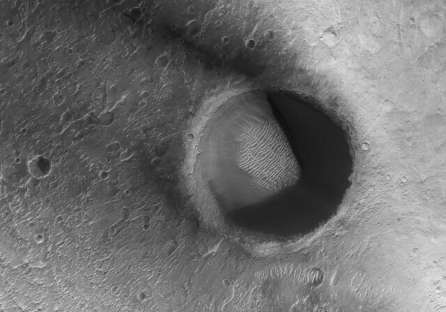 hirise_pacmA sand-filled dune on Mars looks more than a little bit like Pac-Man. Credit: NASA/JPL/University of Arizonaandune
