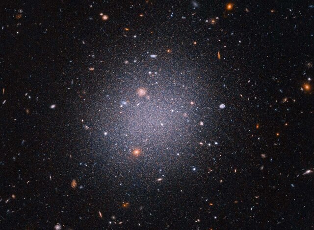 The ultra-diffuse dwarf galaxy NGC 1052-DF2, seen here using Hubble, apparently has little or no dark matter. It’s not clear how this happened. Credit: NASA, ESA, STScI, Zili Shen (Yale), Pieter van Dokkum (Yale), Shany Danieli (IAS) Image processing: Aly