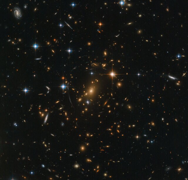 The gigantic galaxy cluster RXC J0142.9+4438 contains several hundred galaxies, and was observed by Hubble to study even more distant background galaxies whose light was amplified by the gravity of the cluster. Credit: ESA/Hubble & NASA, RELICS
