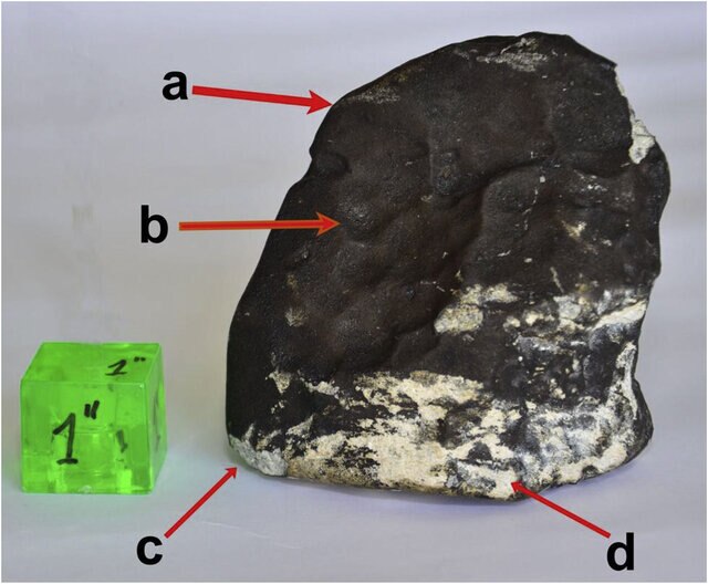 The San Carlos meteorite that hit a house in Uruguay. The green cube is one inch in size. 