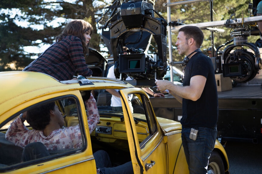 Jorge Lendeborg Jr., Hailee Steinfeld and Director Travis Knight on the set of Bumblebee