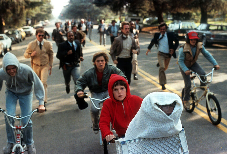Henry Thomas riding with ET in his bike in a scene from the film 'E.T. The Extra-Terrestrial', 1982.