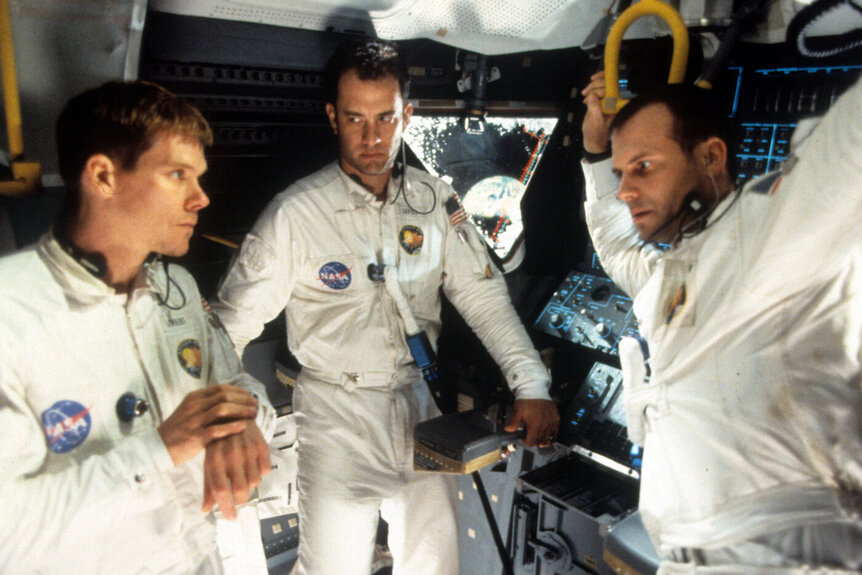 Kevin Bacon, Tom Hanks, and Bill Paxton talking in ship in a scene from the film 'Apollo 13', 1995.