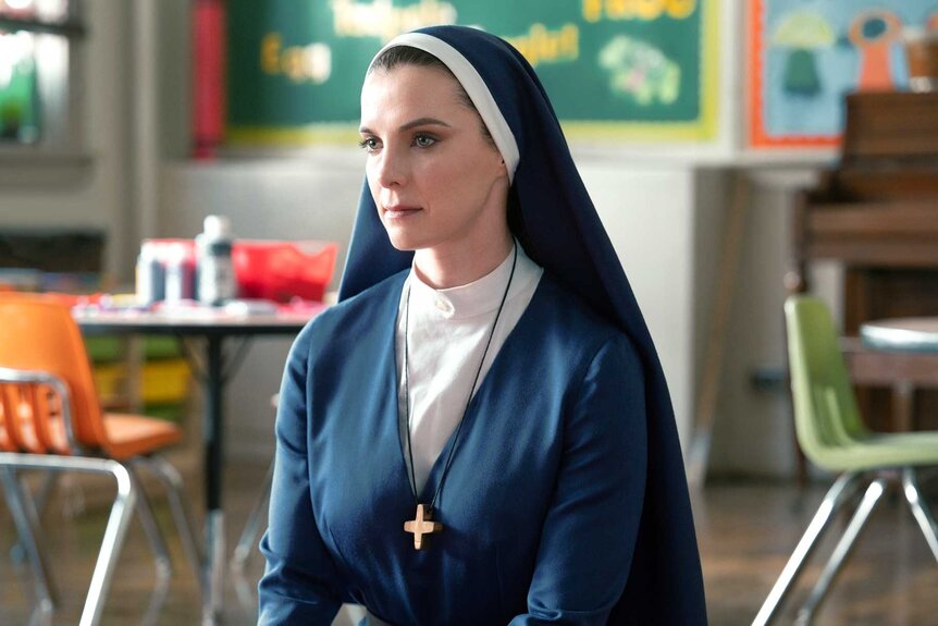 Betty Gilpin as Simone sits in a classroom in Mrs. Davis
