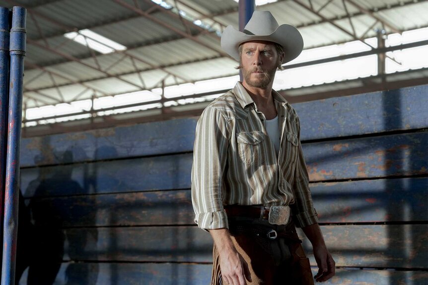 Jake McDorman as Wiley standing in a stable on Mrs. Davis