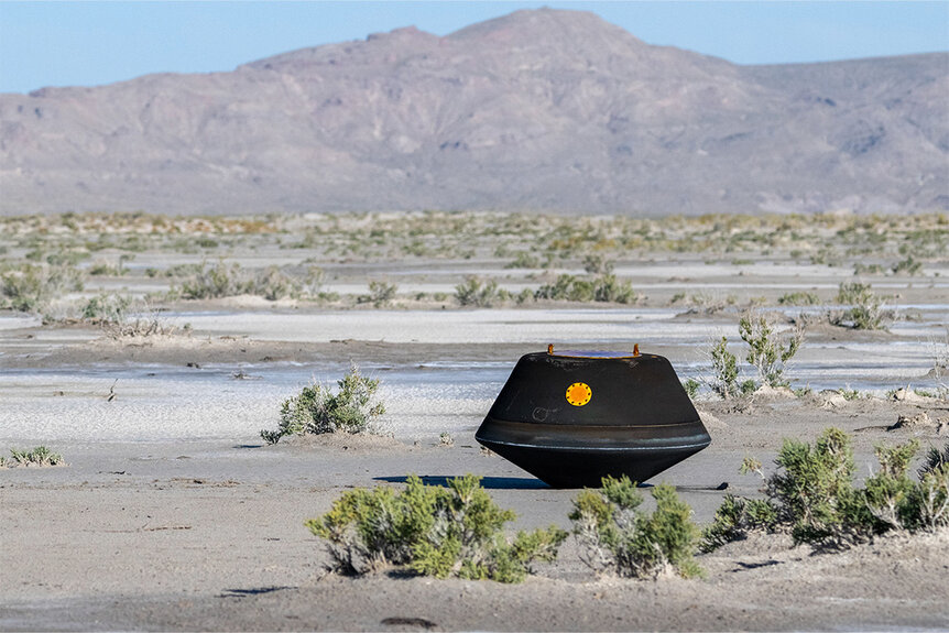 The sample return capsule from NASA’s OSIRIS-REx mission touches down in the desert.