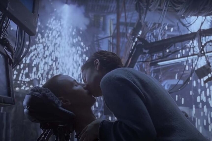 Screenshot 2023 09 06 At 10.27.13 AmaTrinity (Carrie-Anne Moss) kisses Neo (Keanu Reeves) as sparks fly amongst cables in The Matrix (1999)