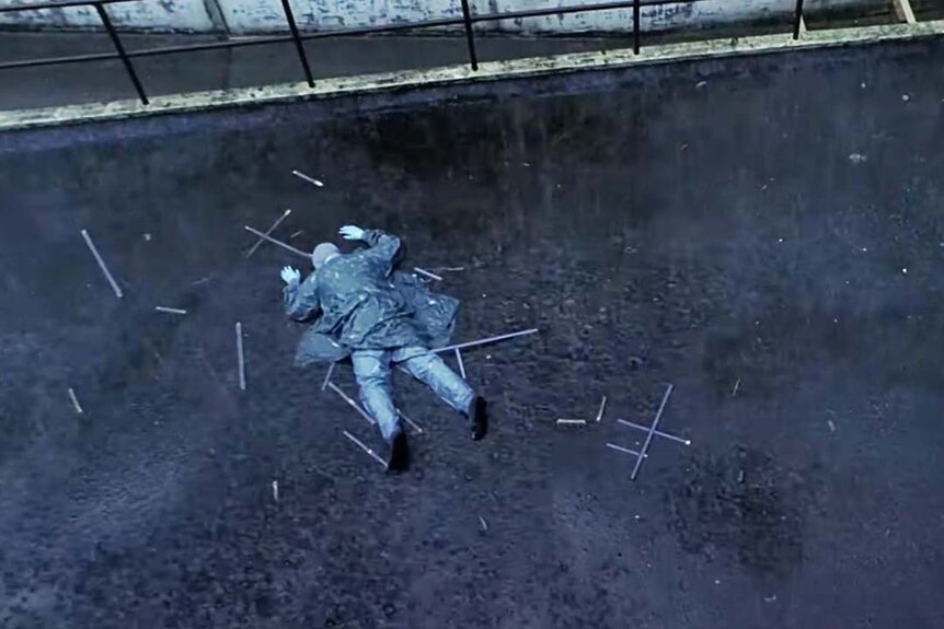 The Hollow Man lays face down on asphalt and broken glass in Hollow Man 2 (2006).