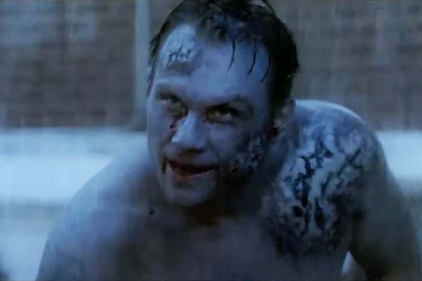 Michael Griffin (Christian Slater) appears battered and blue with tattoos in Hollow Man 2.