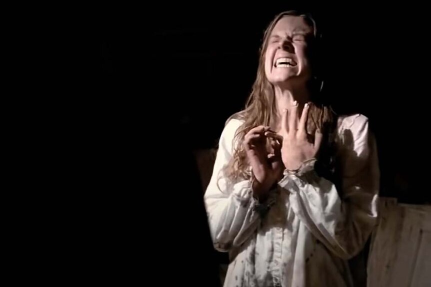 Nell Sweetzer (Ashley Bell) grimaces and screams in The Last Exorcism (2010).