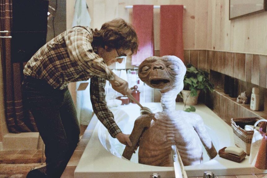 Steven Spielberg gives E.T. a bath in E.T. the Extra-Terrestrial (1982).