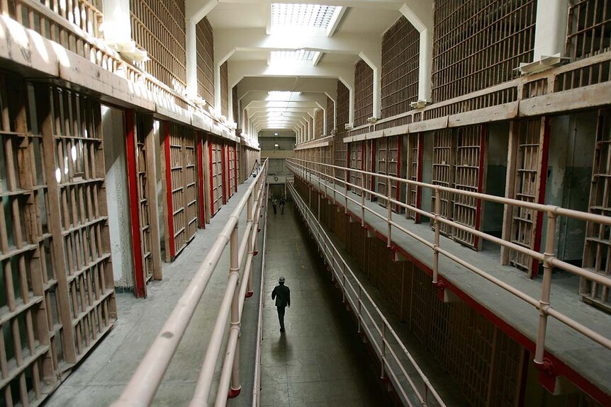A National Park Service ranger walks down prison cells on "Broadway" in the main cell block on Alcatraz Island, 14 June 2007 in San Francisco Bay of California.