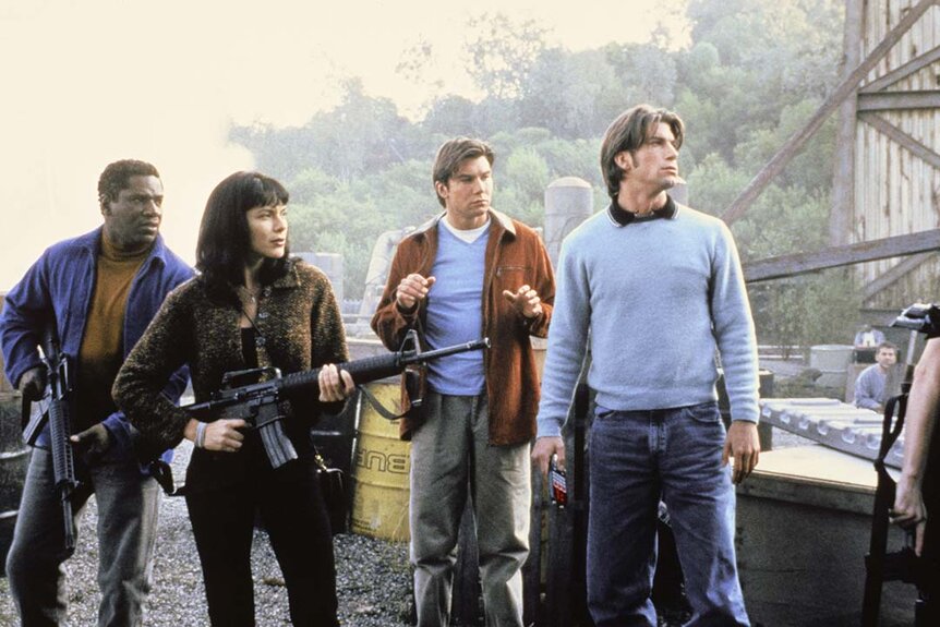 Pictured: (l-r) Cleavant Derricks as Rembrandt 'Crying Man' Brown and Kari Wuhrer as Capt. Maggie Beckett holds guns while Jerry O'Connell as Quinn Mallory and Charlie O'Connell as Colin Mallory stand next to them in Sliders 412.