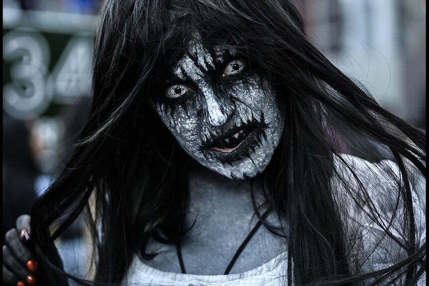 A scary cosplayer with dark makeup poses at New York Comic Con 2023 - Day 1 at Javits Center.