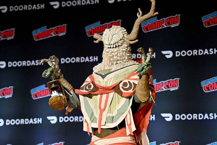 A cosplayer dressed as The Prisoner from Outer Wilds poses during Cosplay Central Crown Championship Qualifier at New York Comic Con 2023 - Day 3 at Javits Center.