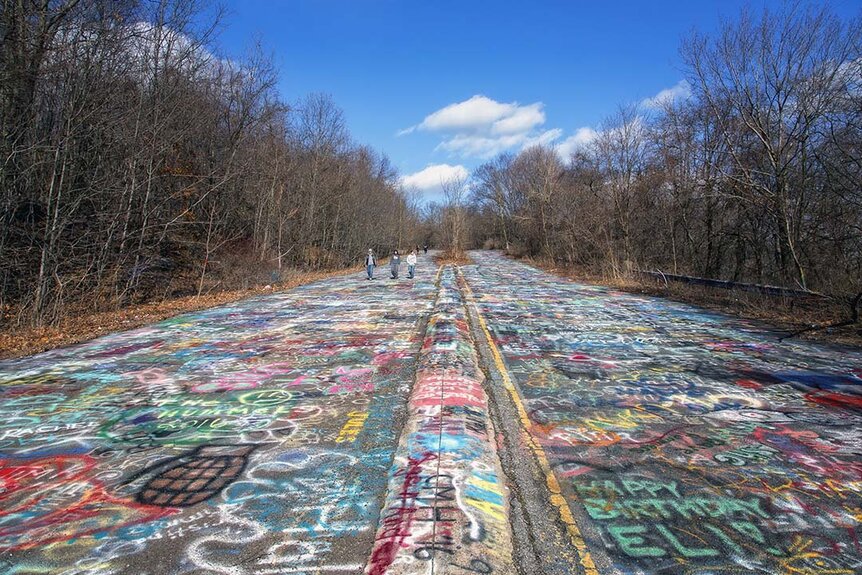 A wide angled view of a graffiti covered abandoned highway in Centralia, Pennsylvania.