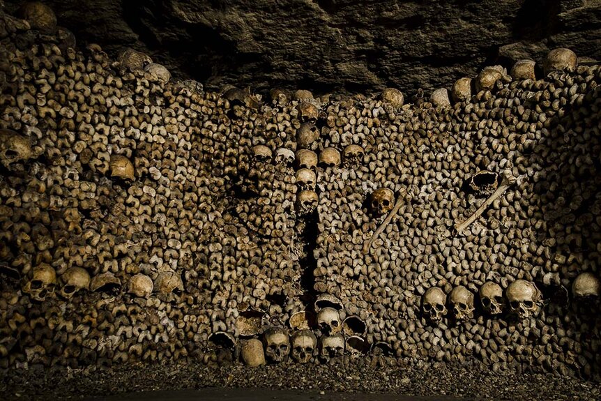 Piled bones inside the catacombs in Paris.
