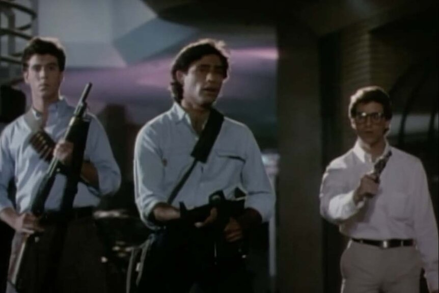 Greg Williams (Nick Segal), Rick Stanton (Russell Todd), Ferdy Meisell (Tony O'Dell) all hold guns inside the mall in Chopping Mall (1986).