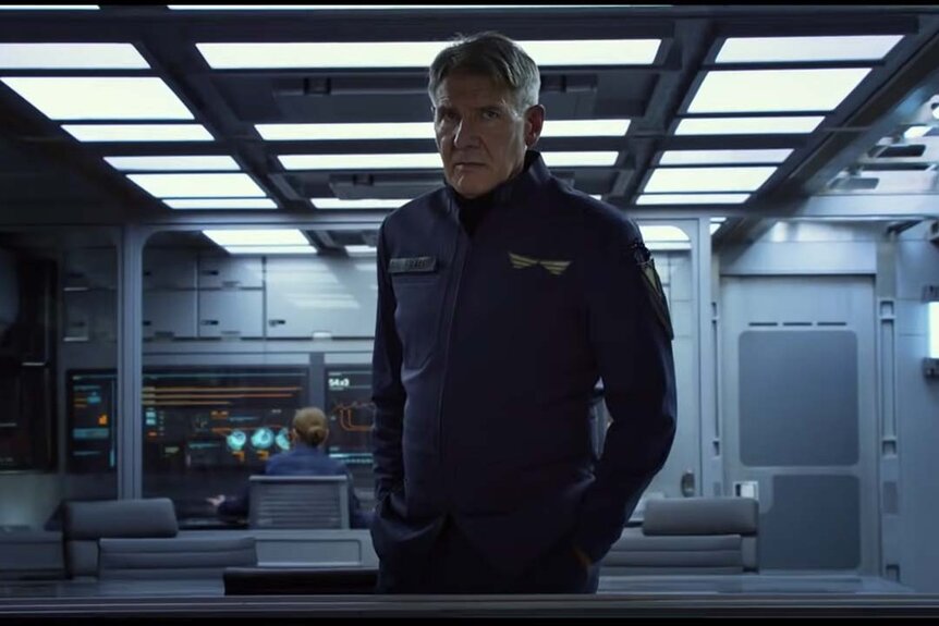 Hyrum Graff (Harrison Ford) appears wearing a space uniform in a control room in Enders Game (2013).