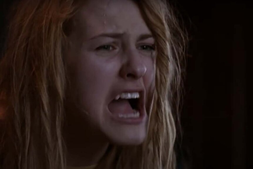 A sweaty, disheveled Laurie Strode (Scout Taylor-Compton) screams in Halloween II (2009).