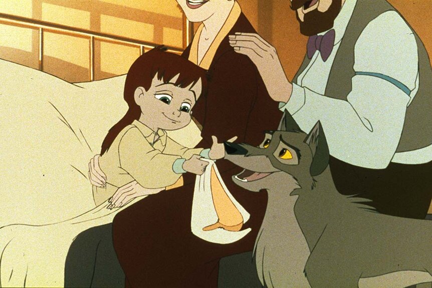 Balto (Kevin Bacon) hands a little boy a hat as his parents watch on in Balto (1995).