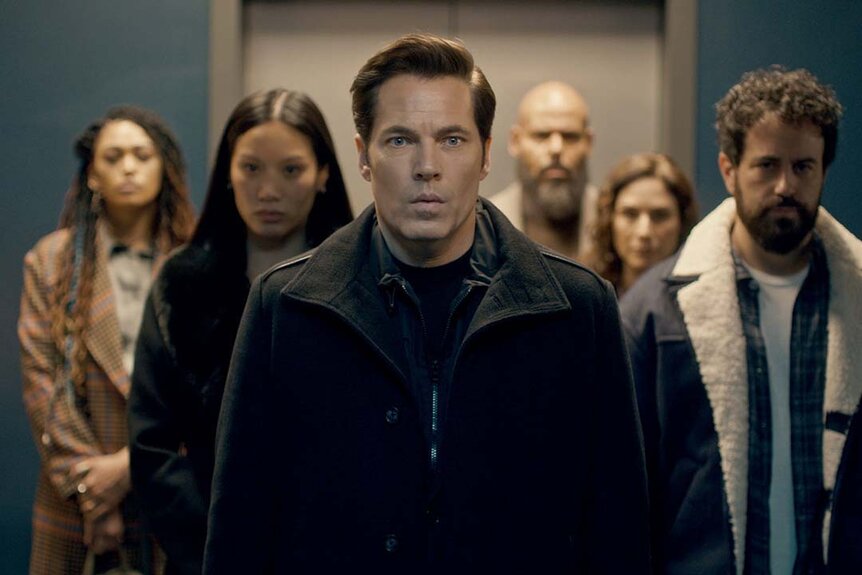 The cast of SurrealEstate appears in a triangle formation facing forward with Luke Roman (Tim Rozon) at the head in SurrealEstate Season 2 Episode 9 -- "Dearly Departed"