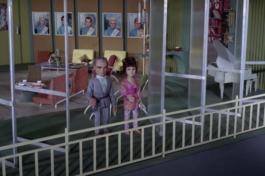 Two puppets stand on a balcony of a mansion in Thunderbirds (1965)