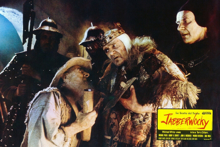 King Bruno the Questionable (Max Wall)(right) speaks to Passelewe (John Le Mesurier) (left) while surrounded by kingsuards in Jabberwocky (1977).