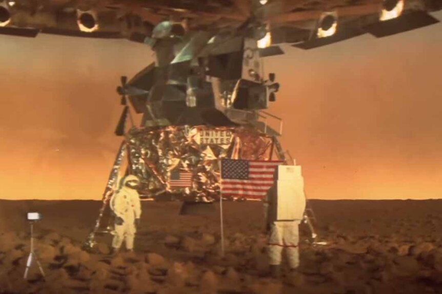 Astronauts walk around on a moon landing film set in Capricorn One (1977).